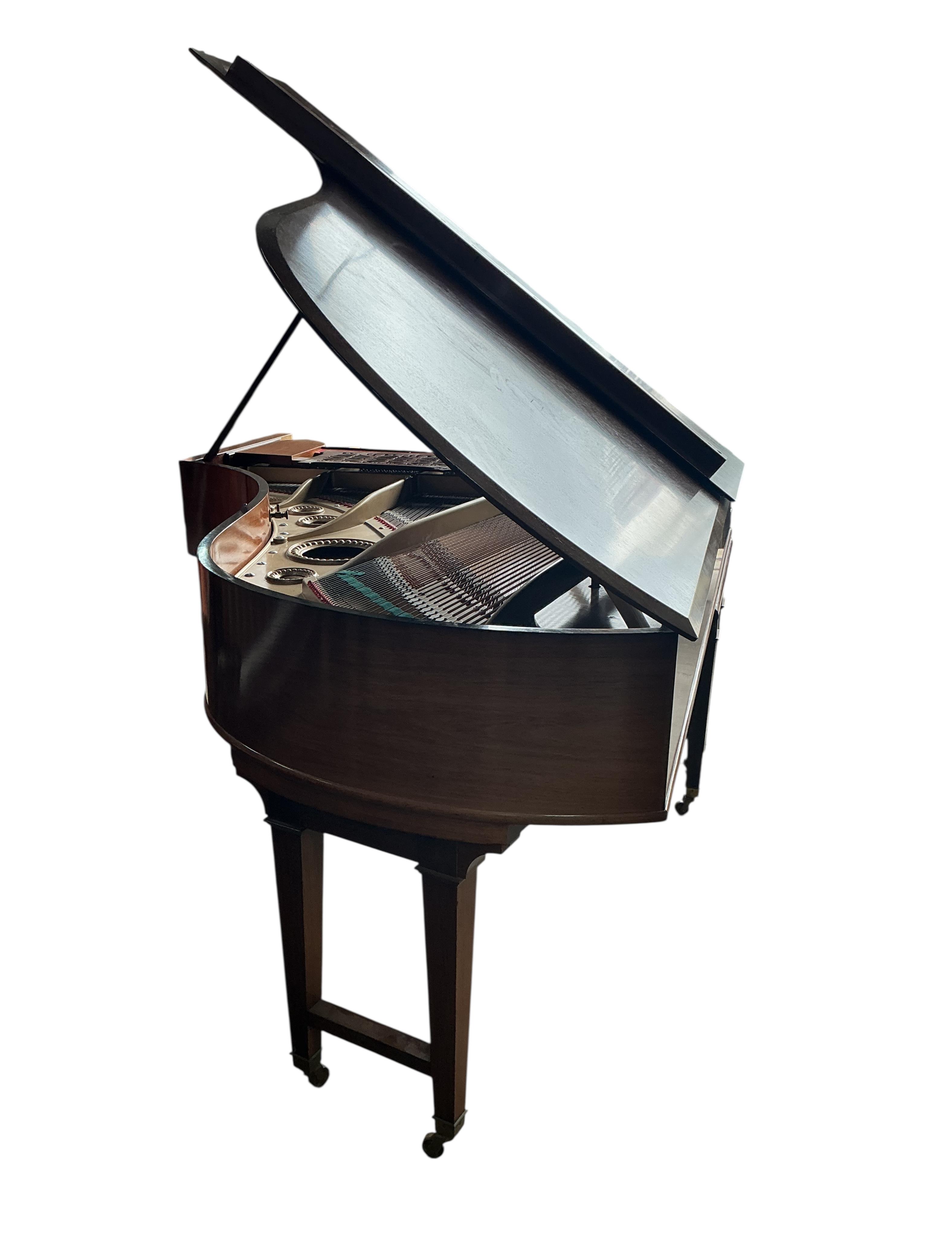 An early 20th century Bechstein 6ft. 8in. rosewood grand piano retailed by Harrods and duet piano stool